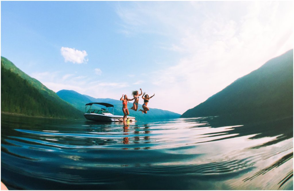 shuswap lake girls jumping off of mastercraft boat summer