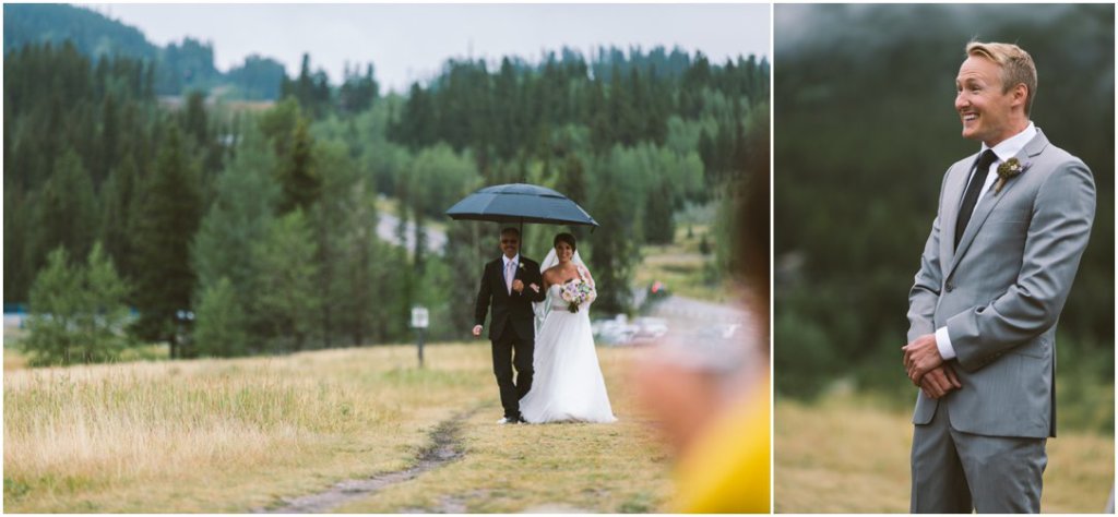 rainy canmore wedding bride walking up aisle and grooms response