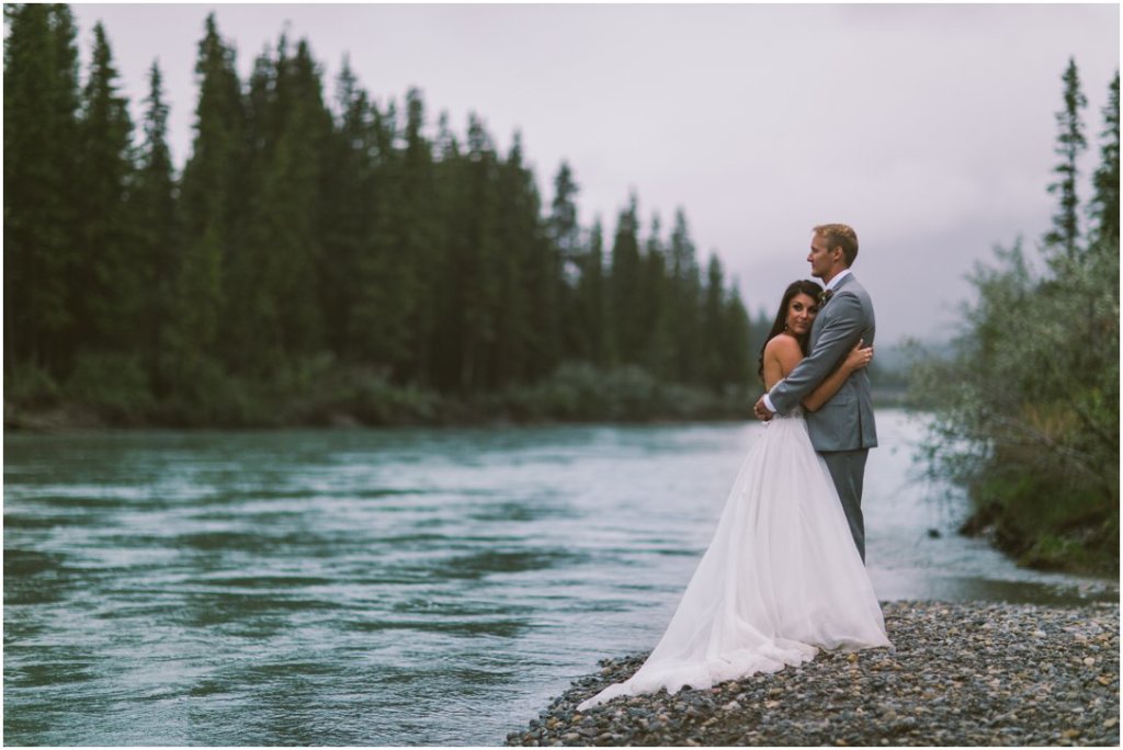 canmore alberta wedding bride and groom by river 