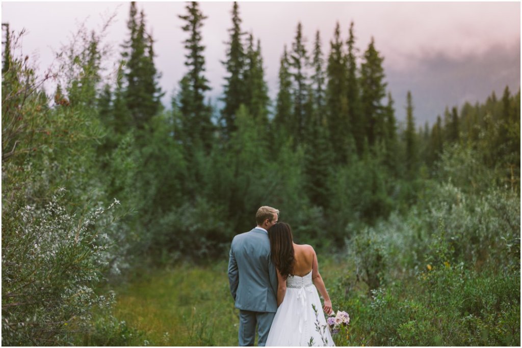 canmore alberta wedding bride and groom by river raining