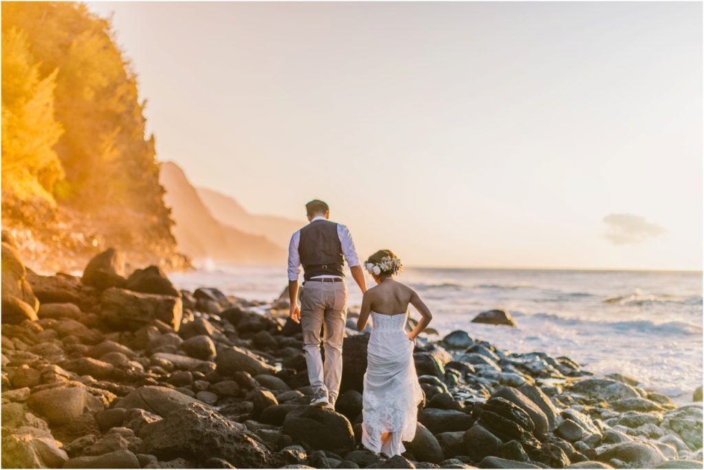 ke'e beach kauai hawaii elopement bride and groom at sunset on lava rocks photos by meg courtney
