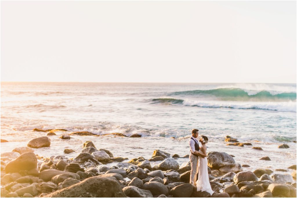 North Shore ke'e beach kauai hawaii elopement bride and groom at sunset on lava rocks- drone photo by bradyhouse media